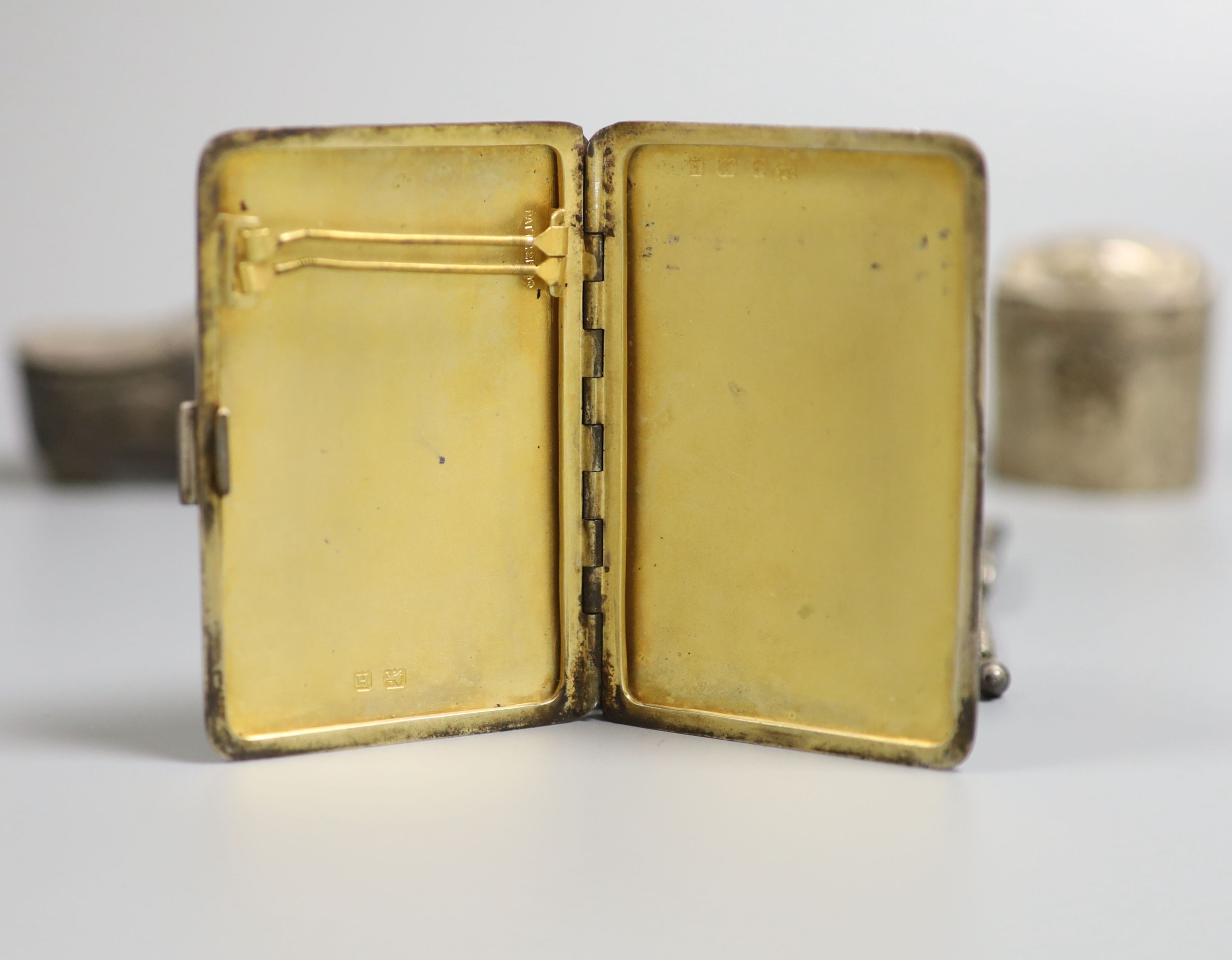 A late Victorian silver shoe vinaigrette, import marks for Sheffield, 1896, 7cm, one other continental white meta box, a silver cigarette case and a mesh evening bag.